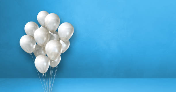 istock White balloons bunch on a blue wall background. Horizontal banner. 1328635714