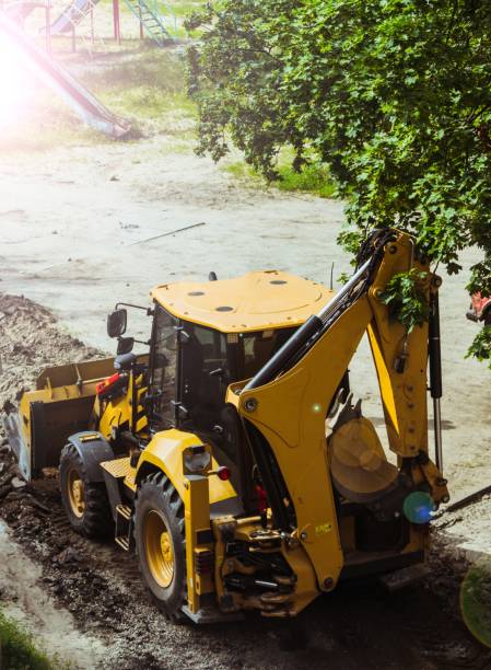 istock Excavator loader removes the remains of broken asphalt. 1328635737