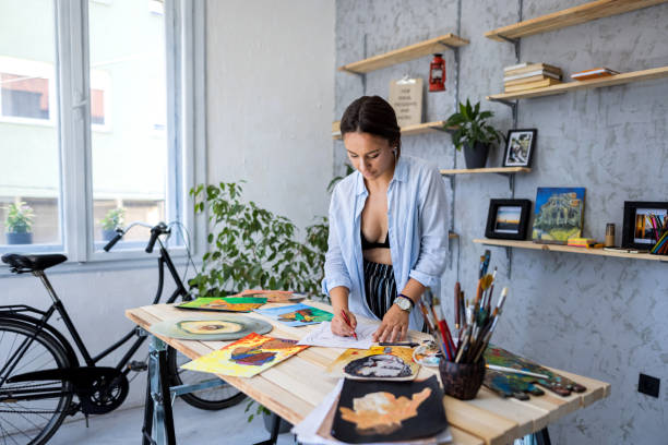 istock Beautiful woman drawing in her art studio 1328641666