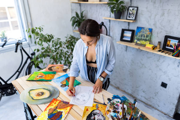 istock Beautiful woman drawing in her art studio 1328641669