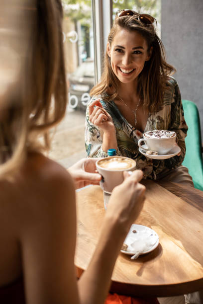 istock Relaxing women enjoying coffee together 1328641869