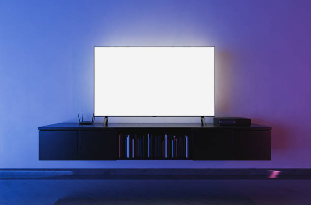 modern tv on living room front view of a white backlit television mockup in a living room with blue and red lighting. 3d render channel stock pictures, royalty-free photos & images