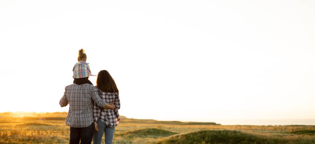 family tourists mother father and daughter child at sunset. Back view and silhouettes in summer evening. Happy family relationship concept. Parenting and childhood. Travel as a way of life. Family tourists mother father and daughter child at sunset. Back view and silhouettes in summer evening. Happy family relationship concept. Parenting and childhood. Travel as a way of life. Banner. will stock pictures, royalty-free photos & images