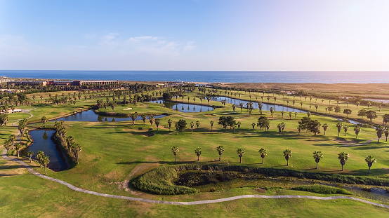 Green golf courses by the sea. Portugal, Albufeira. Aerial view. High quality photo