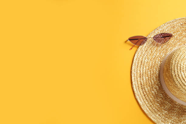 istock Hat and sunglasses on yellow background, flat lay with space for text. Sun protection accessories 1328647070