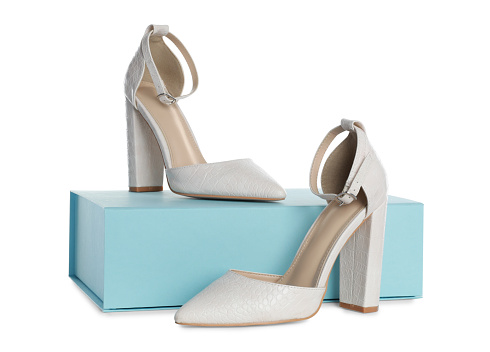 Pair of stylish shoes and turquoise box on white background