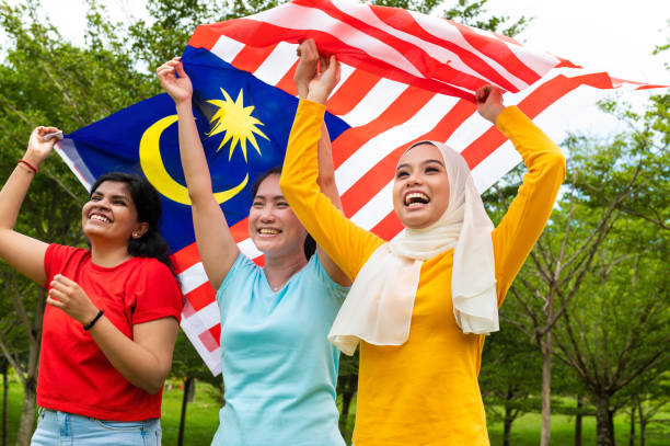Malaysia three major multi ethnic groups comprising of Malay, Chinese and Indian have high patriotism spirit celebrating Hari Merdeka on 31st August at public park, Kuala Lumpur Malaysia.