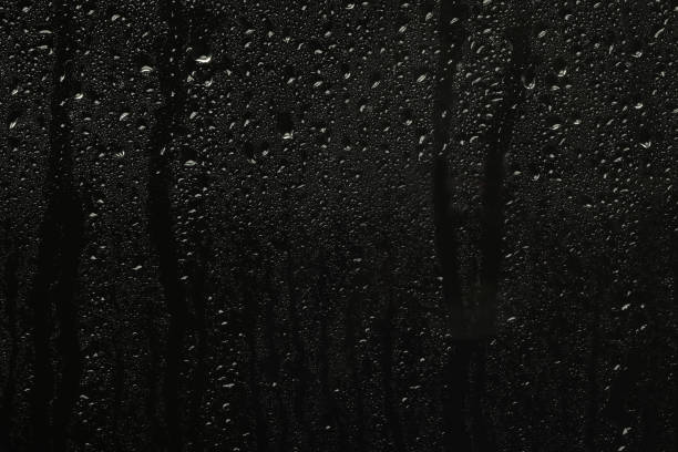 istock Glass with rain drops on black background 1328648543