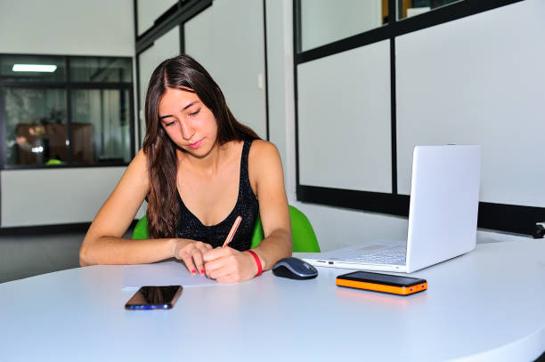 istock Attractive young executive, concentrated on her work, sitting at the office table. 1328648889