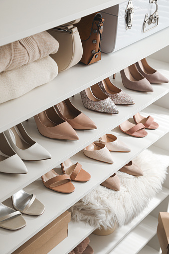 Zapatos, ropa y bolsos elegantes para mujer en estanterías photo