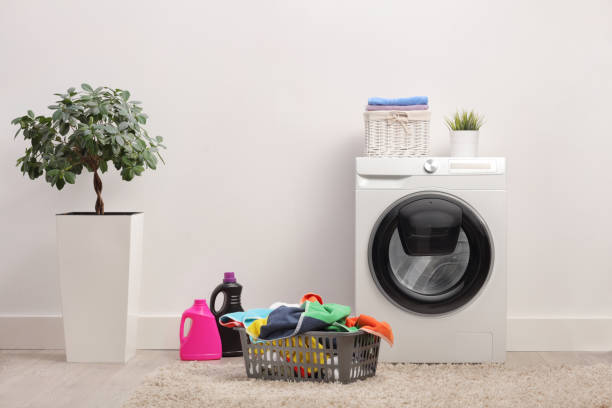 istock Washing machine and a laundry basket 1328649685