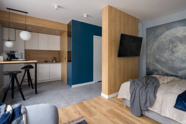 Stylish designed studio apartment Stylish designed studio apartment with kitchen open to living room and bedroom with tv studio apartment stock pictures, royalty-free photos & images