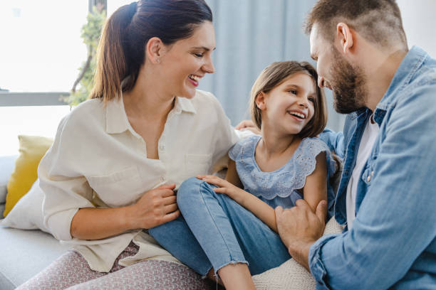 istock Happy family at home on the sofa 1328655257