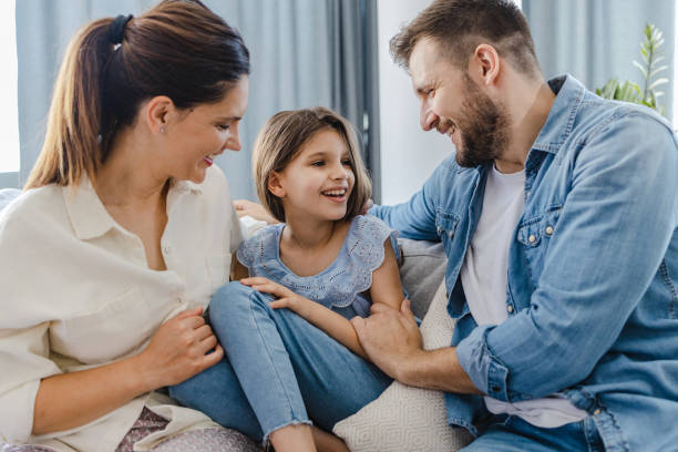 istock Happy family at home on the sofa 1328655317