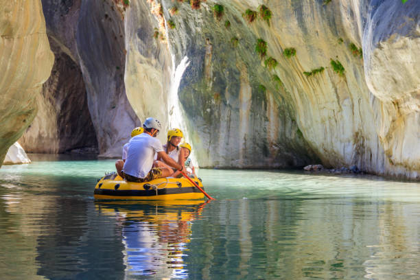 Tourists rafting in rubber boat in Goynuk canyon located in District of Kemer, Antalya Province in Turkey Goynuk, Turkey - October 22, 2020: Tourists rafting in rubber boat in Goynuk canyon located in District of Kemer, Antalya Province in Turkey rubber rocks stock pictures, royalty-free photos & images