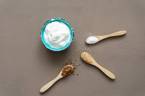 istock Yogurt in a bowl and variation of sugar on spoons 1328657464