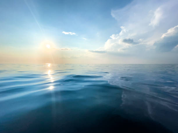 istock Blue calm sea with few ripples, sun and sky. 1328659300