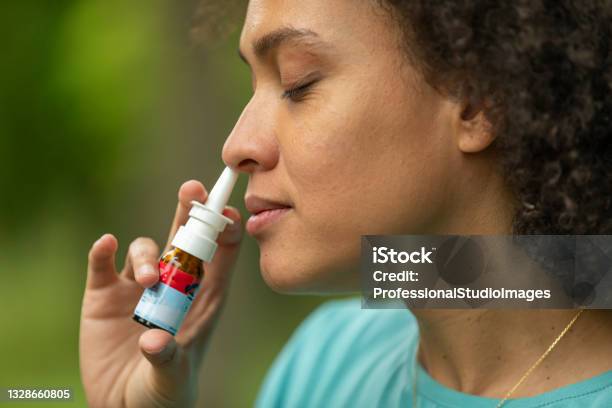 Young Africanamerican Woman With Asthma Is Using Inhaler In A Park Stock Photo - Download Image Now