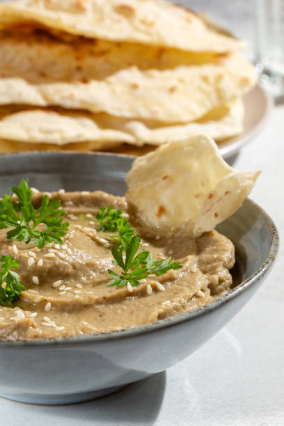 istock Baba ghanoush, babaganush or baba ganoush in gray bowl served with  oriental flatbread on concrete background. Turkish cuisine. Close-up. 1328661688