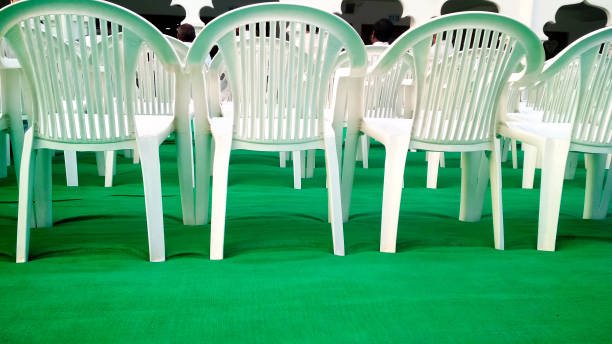 istock Rows of empty white chairs waiting for the audience in india 1328662107