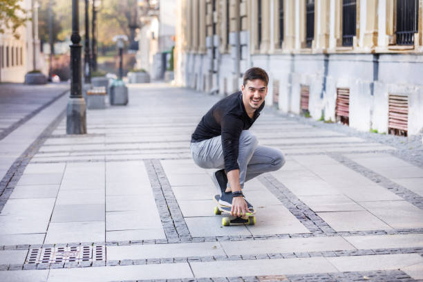 istock A Young Man is Enjoying Vacation While Riding a Skateboard in the City and Exploring. 1328663392