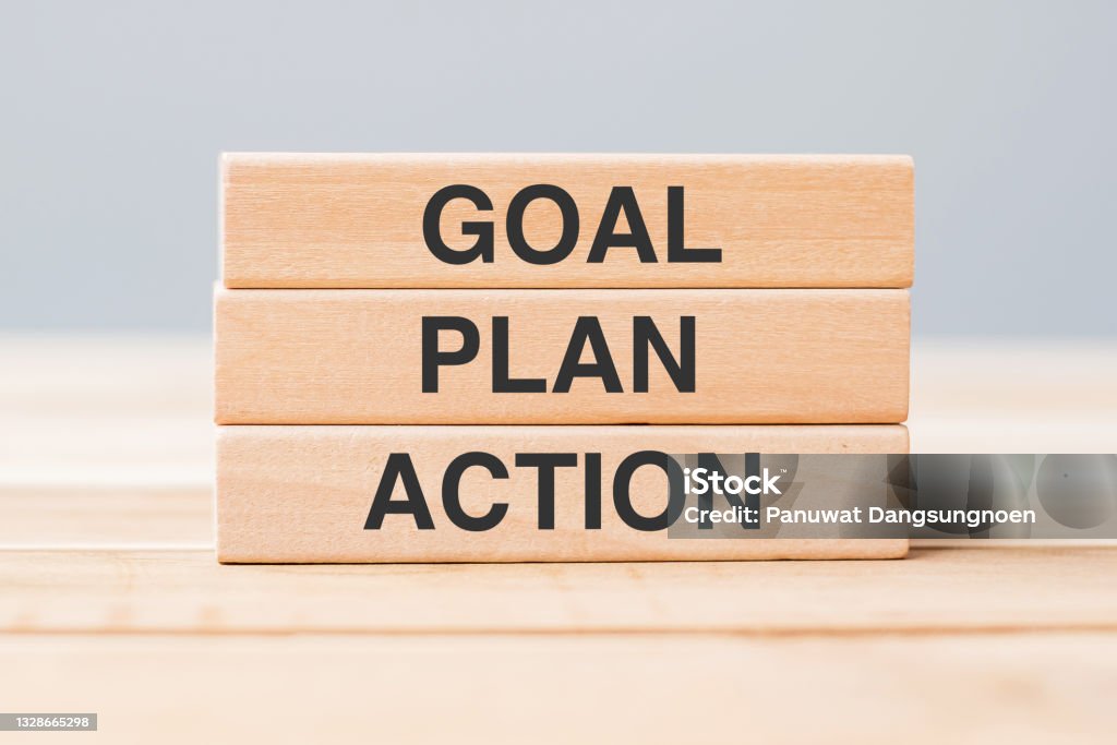 wooden block with GOAL, PLAN and ACTION on table background Planning Stock Photo