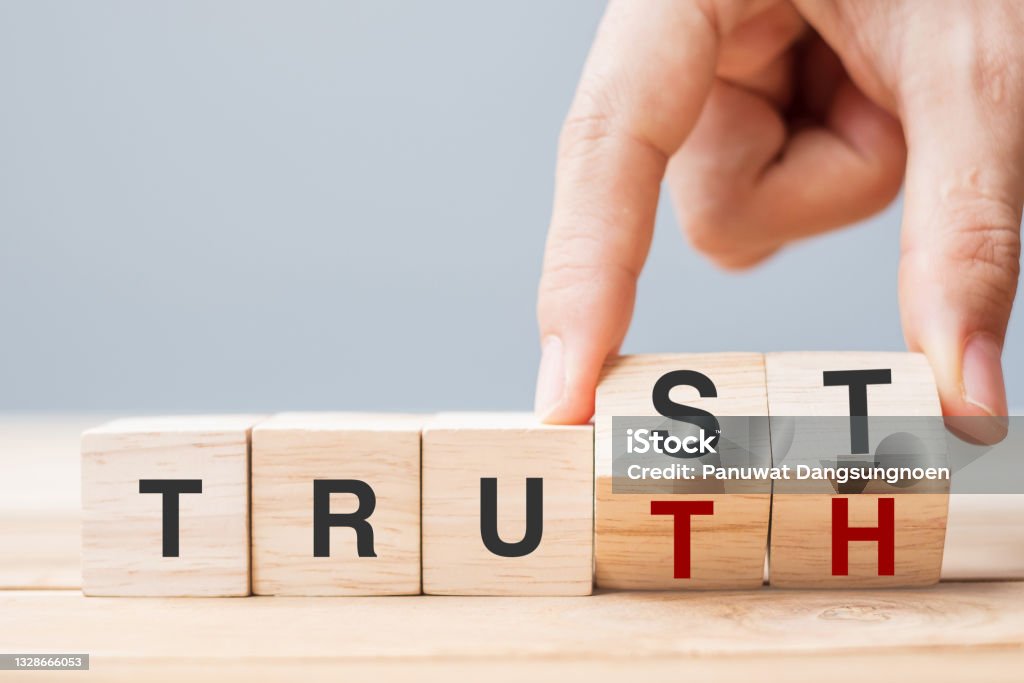 Business man hand change wooden cube block with TRUST and TRUTH business word on table background. Trustworthy, faith, beliefs and honesty concept Honesty Stock Photo