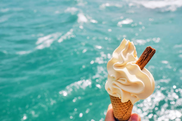 istock Ice cream cone against shimmering sea background at Newquay, Cornwall. 1328666087