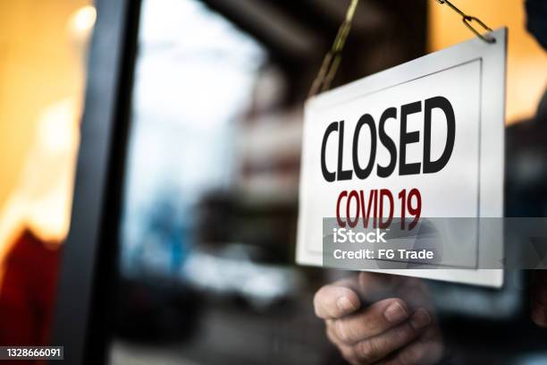Closed Sign On A Store Window Stock Photo - Download Image Now - Closed, Coronavirus, Closed Sign