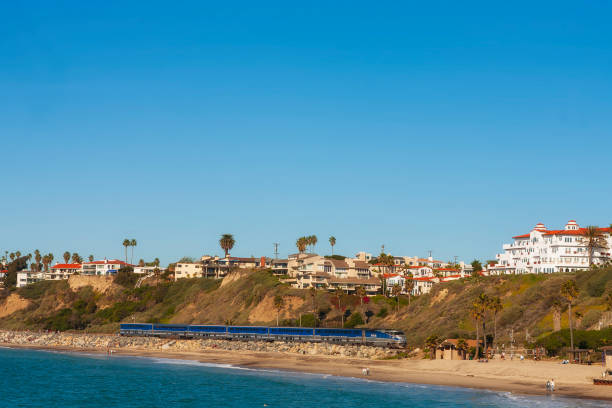 Amtrak's Pacific Surfliner, traveling south on the west coast through San Clemente, Southern California, on a cloudless, winter day. San Clemente, CA - Dec 20, 2008: Amtrak's Pacific Surfliner, traveling south on the west coast through San Clemente, Southern California, on a cloudless, winter day. Amtrak stock pictures, royalty-free photos & images