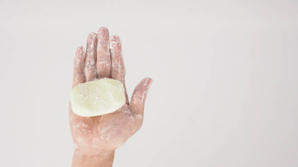istock Hands washing gesture with bar soap and foam bubble on white background. 1328667914