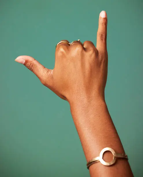 Photo of Shot of a hand making a gesture shot against a studio background