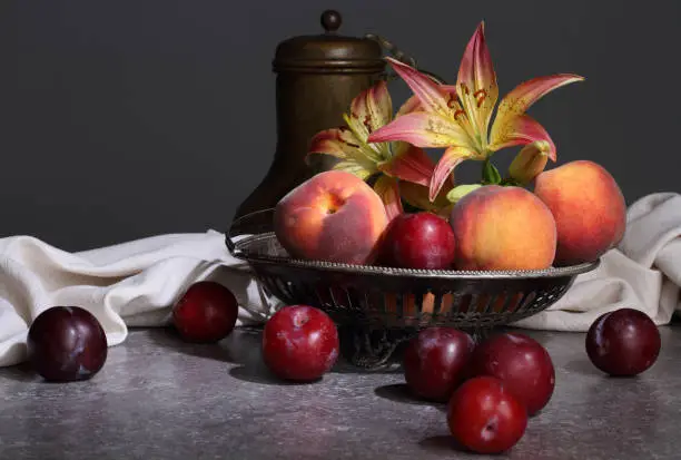 Photo of Still life with fruits and lilies in retro style