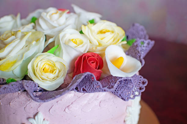 istock Beautiful birthday cake with mastic flowers decor. 1328671027