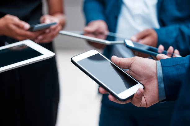 istock Shot of a group of unrecognizable businesspeople using their mobile devices 1328676374