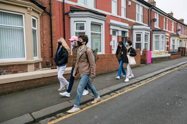 istock Friends Walking Along Street 1328676794