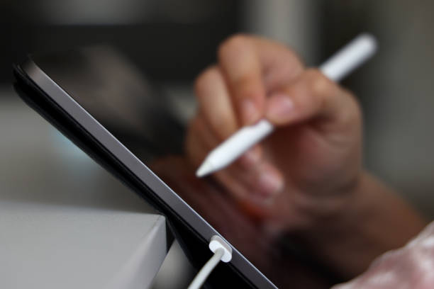 istock Close up of female hand using digital pen writing on digital tablet screen 1328678887