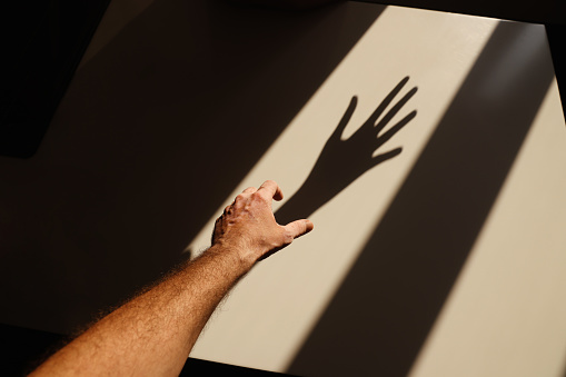 Hands Reaching Shadow