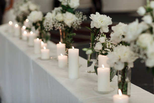 istock Table setting at wedding reception. Floral compositions with beautiful flowers and greenery, candles on decorated table. Coziness and style. Modern event design. selective focus. 1328681262