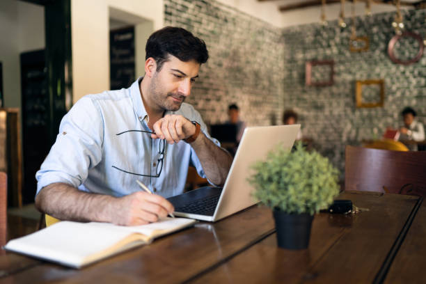 istock Handsome young businessman working online in a restaurant 1328682714