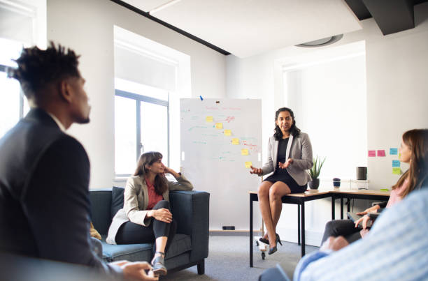 istock Manager talking with her staff during a casual office meeting 1328689614