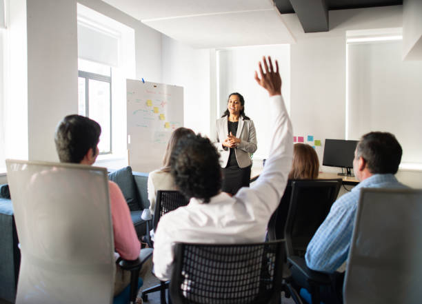 istock Smiling manager taking questions from staff during a meeting 1328689660