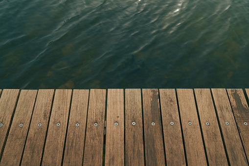 Wooden plank boardwalk by a natural water body