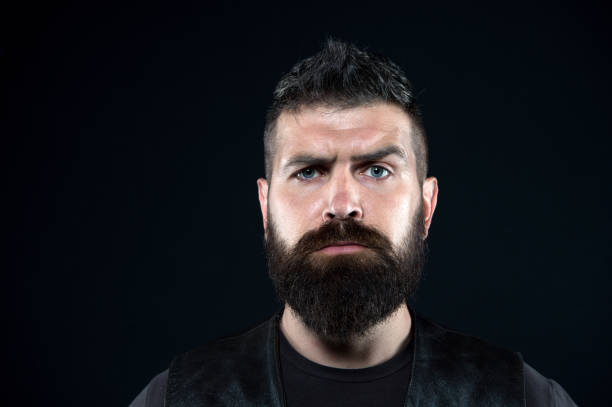 istock Because its your beard. Serious hipster with long beard dark background. Bearded man with stylish mustache and beard shape. Mens grooming salon. Beard barber. Fashion barbershop 1328696473
