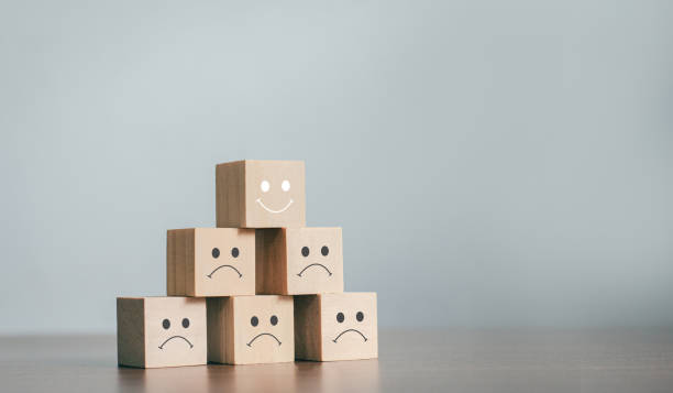 istock The best business services rate the customer experience. sorted by service level Satisfaction Survey Concept With a business wooden block, choose a smiley face on the top wooden block. 1328697524