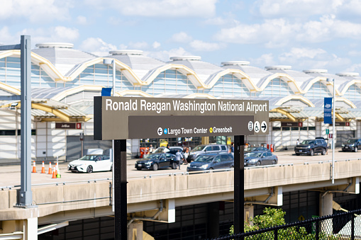 Washington D.C. USA- July 12th, 2021: The sign for Washington National Airport with the airport terminal in the background.