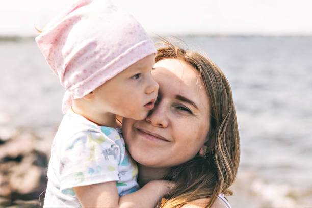 istock A young mother with a child on the beach 1328703926