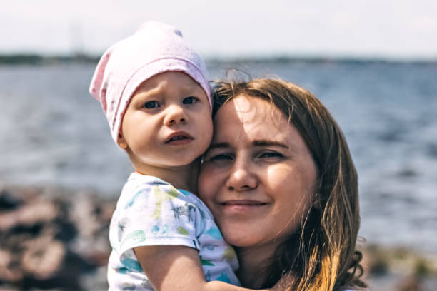 A young mother with a child on the beach