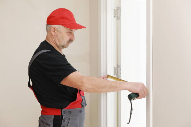 istock Worker in red cap and work suit with the measuring tape. Man is installing the doors. Measure tape in hands. Repair works. Maintenance in the apartment. 1328707107