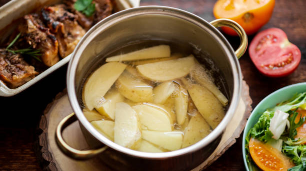 istock Cooking boiled young potatoes in a saucepan. 1328708058